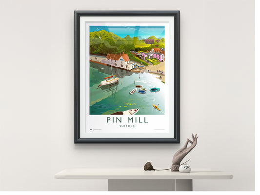 Framed travel poster of Pin Mill, Suffolk, in a modern home interior.