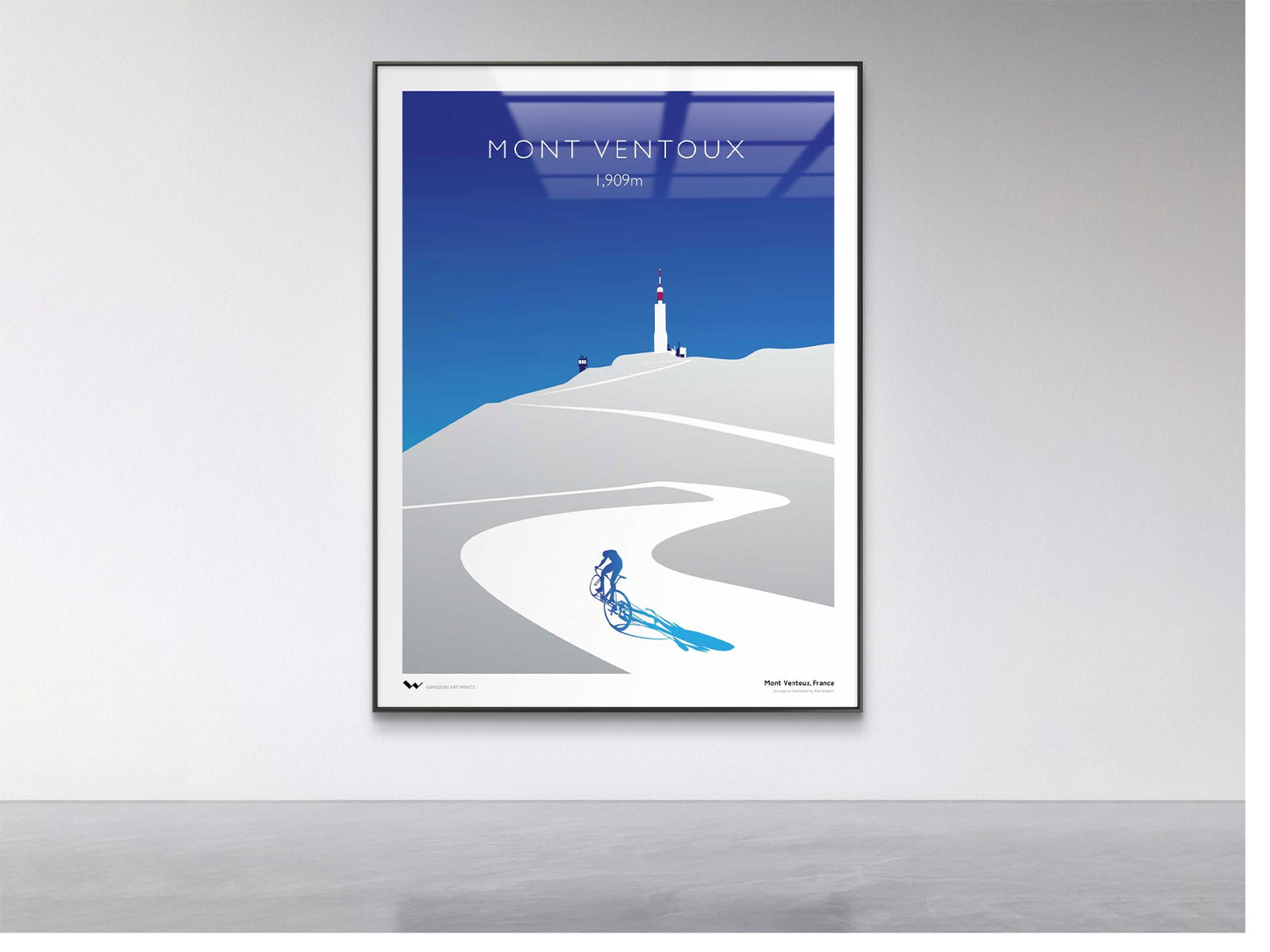 Framed artwork of a mountain bike climb with 'Mont Ventoux' text on a white wall.
