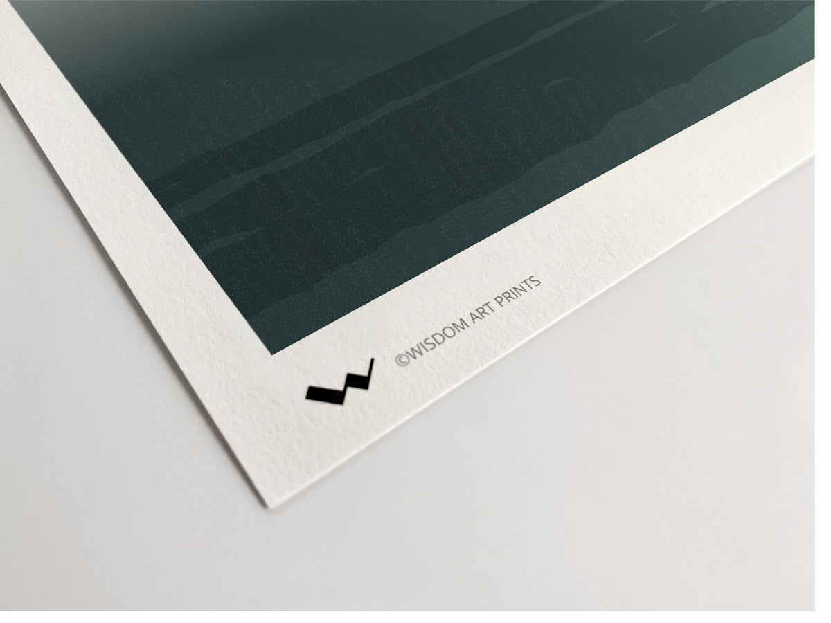 Close-up of an art print corner showing a dark teal landscape illustration with a wide white border and the text '@WISDOM ART PRINTS' printed along the bottom edge.