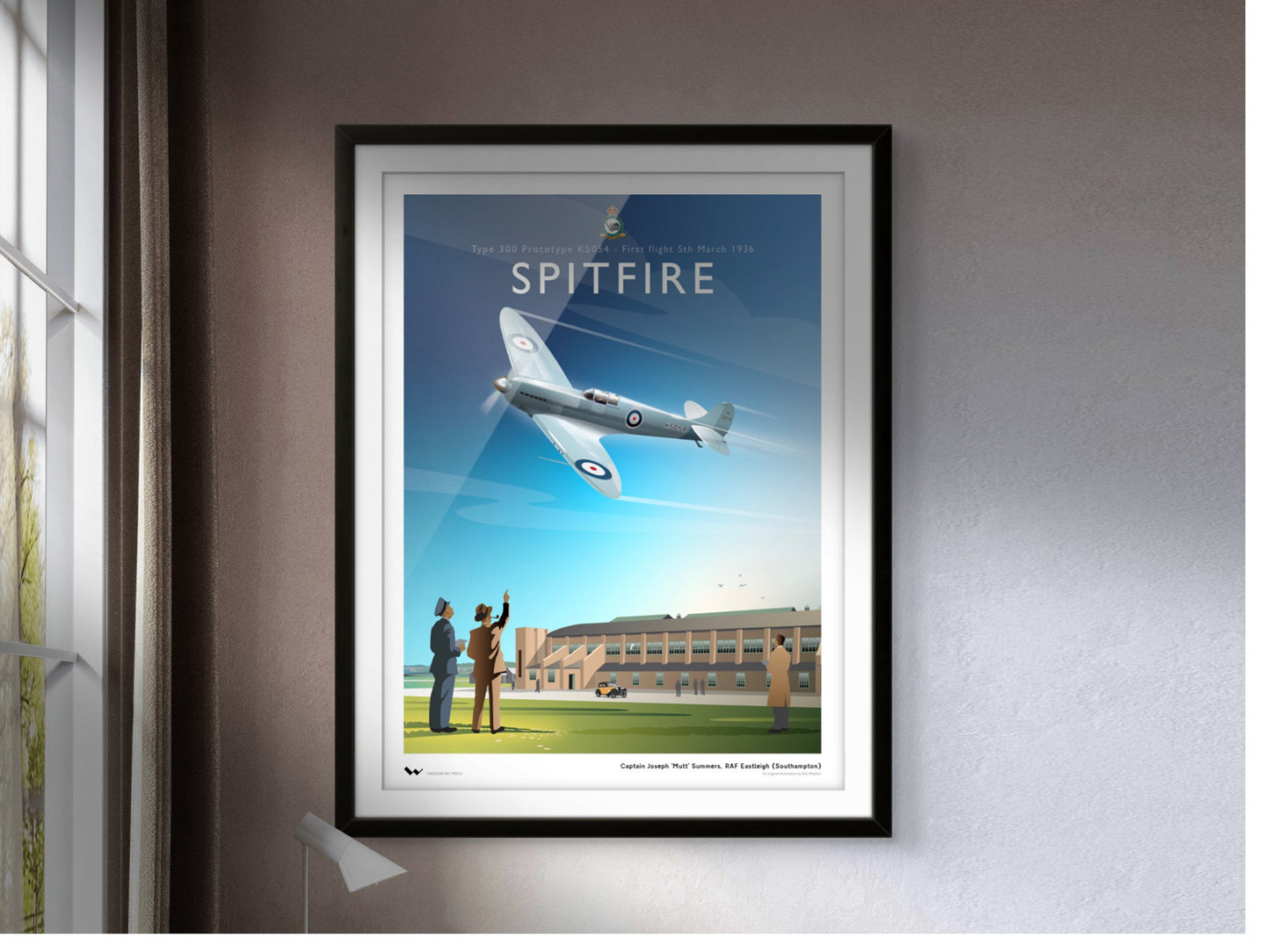 Original art print of the original Spitfire prototype K5054, shown here in a white and black frame, against a grey wall, window left admitting light.
