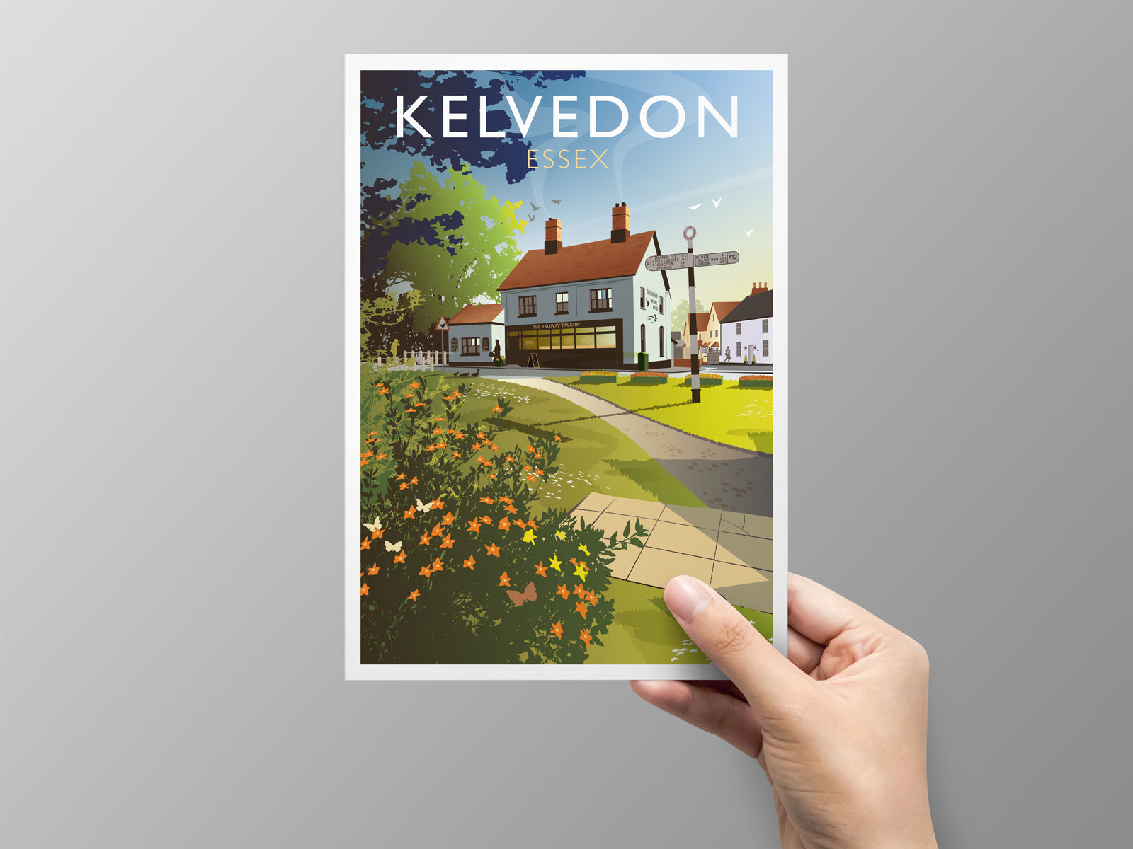 Greeting card of Kelvedon, Essex held by a hand against a gray background