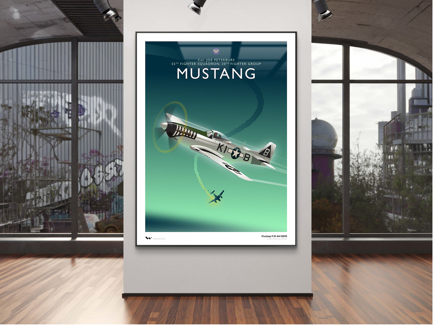 A framed vintage-style Mustang poster featuring a teal and green gradient background with a white and black airplane and the word 'MUSTANG' at the top, displayed on a wall in a modern room with large windows and wood flooring.